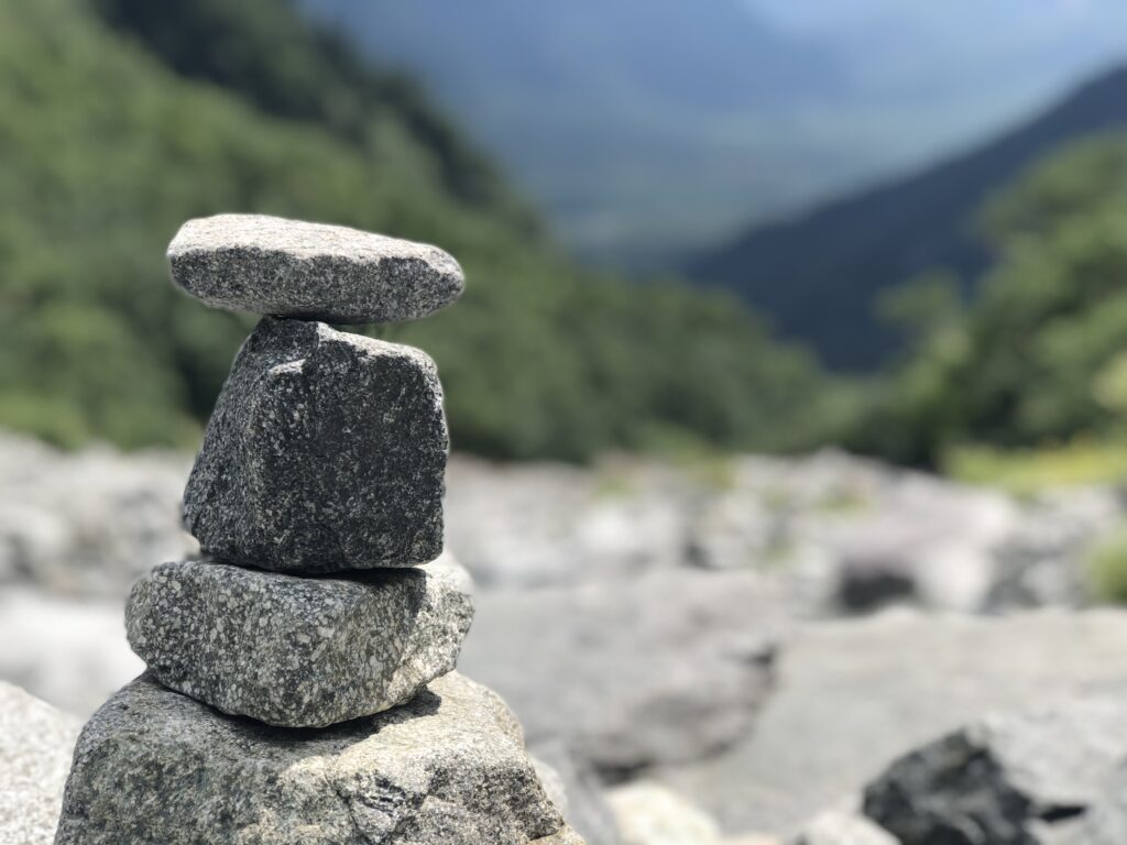 rocks piled in little tower in nature